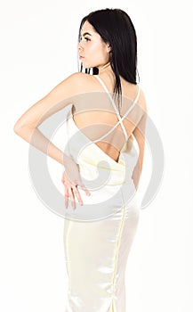 Fashion wedding concept. Woman in elegant white dress with nude back, white background. Fashion model demonstrate