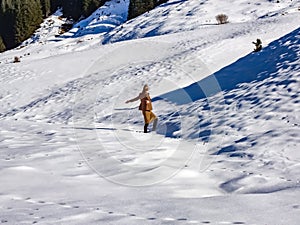 Fashion winter woman walking in the snow of the alps