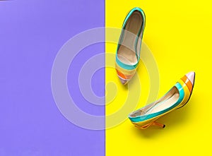 Fashion woman accessories set. Trendy fashion colorfull shoes heels oh the purple and yellow background