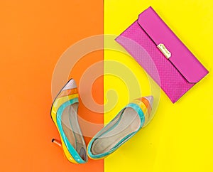 Fashion woman accessories set. Trendy fashion shoes heels, stylish handbag clutch. Colorfull background.