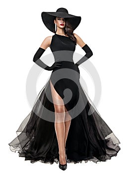 Fashion Woman in Black Evening Dress isolated White. Elegant Lady in Black Summer Hat and Long Luxury Gown with Slit. Beautiful photo