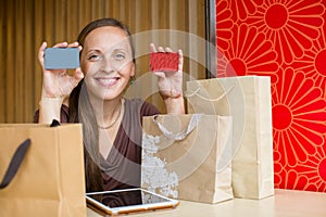 Fashion woman buying online with smart phone and credit card wit