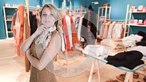 Fashion woman in clothes shop on abstract blur beautiful luxury shopping mall retails store interior blurry background