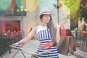 Fashion woman dressed in striped dress with bags