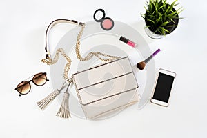 Fashion woman handbag with cellphone, makeup and accessories