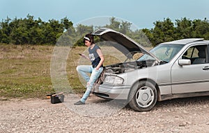 Fashion woman having troubles with car