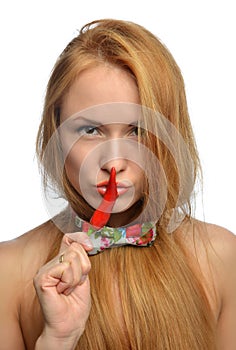 Fashion woman holding red chilli pepper in her mouth