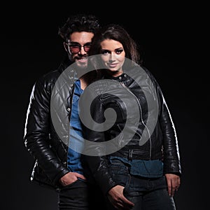 Fashion woman in leather jacket standing against her boyfriend