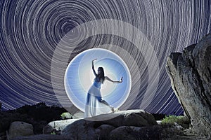 Fashion Woman Light Painted Under the North Star Trails