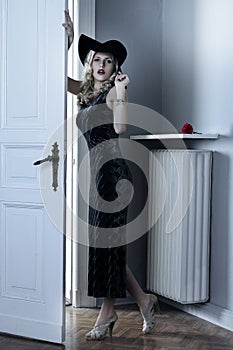 Fashion woman with long black dress and hat