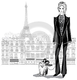 Fashion woman model in a pantsuit with a little dog on Paris cit