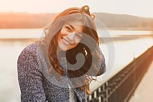 Fashion woman outdoor portrait. Beautiful girl posing on the street in black coat. Photo toned style instagram filters