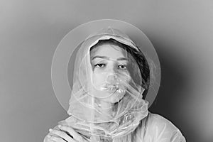 Fashion woman with polyethylene or plastic raincoat and bag