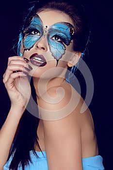 Fashion woman Portrait. Butterfly makeup, face art make up