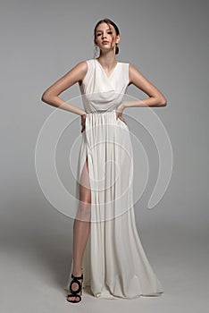 Fashion woman portrait in white long flying airy dress