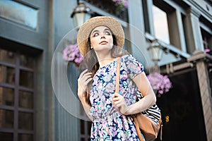 The fashion woman portrait of young pretty trendy girl posing at the city in Europe