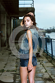 Fashion woman posing against the storm sky