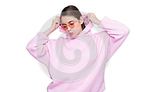 Fashion woman pouting lips in casual pink hoodie isolated on white