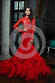 Fashion Woman in Red Dress. Beautiful model wearing Long Evening Red Gown