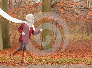 Fashion woman running in fall autumn park forest.