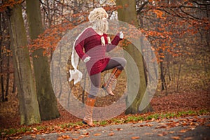 Fashion woman running in fall autumn park forest.