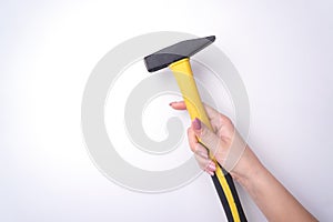 Fashion woman`s hand with a gentle manicure holds a tool. Safe work, place for an inscription. View from above. White background,