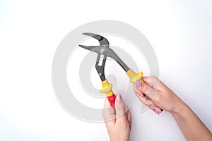 Fashion woman`s hand with a gentle manicure holds a tool. Safe work, place for an inscription. View from above. White background,