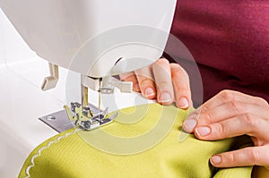 Fashion woman sews with sewing machine