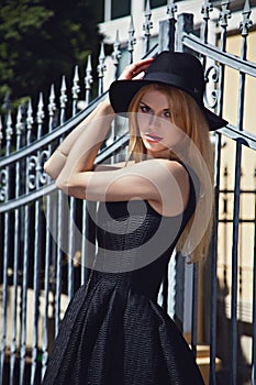 Fashion Woman Standing Near Metal Fence