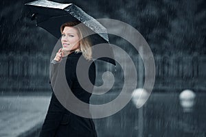 Fashion woman with umbrella walking in the rain