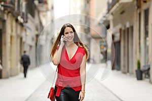 Fashion woman walking and talking on the mobile phone