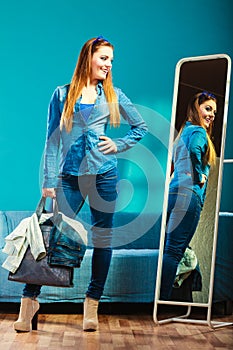 Fashion woman wearing blue denim in front of mirror