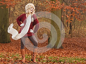 Fashion woman in windy fall autumn park forest.