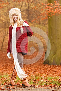 Fashion woman in windy fall autumn park forest.