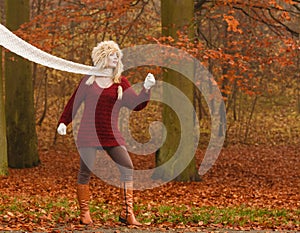 Fashion woman in windy fall autumn park forest.