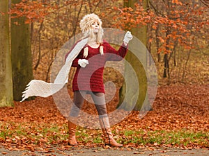 Fashion woman in windy fall autumn park forest.