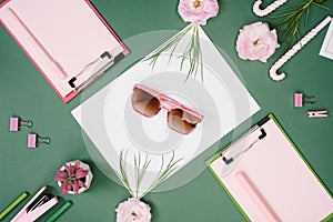 Fashion workspace with stationary and sunglasses