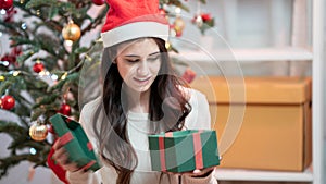 Fashion young beautiful woman in knitted dress near Christmas tree.