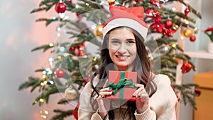 Fashion young beautiful woman in knitted dress near Christmas tree.