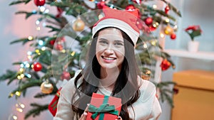 Fashion young beautiful woman in knitted dress near Christmas tree.