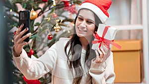 Fashion young beautiful woman in knitted dress near Christmas tree.