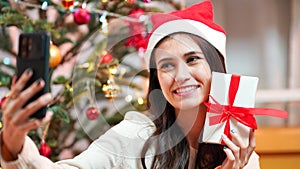 Fashion young beautiful woman in knitted dress near Christmas tree.