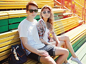 Fashion young couple teenagers are resting in the city