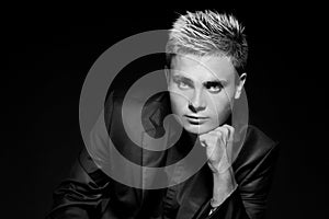 Fashion young handsome man. Black and white photo. Studio portrait.