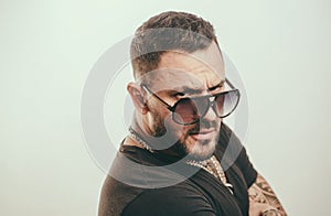 Fashion young man with sunglasses. Handsome guy with confident face. Close up face, portrait.