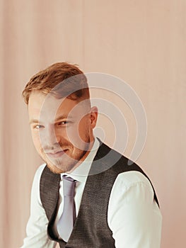 fashion young man wearing black tuxedo, grain effect studio blond