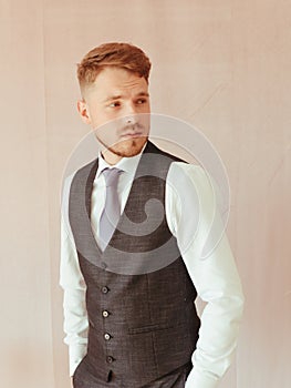 fashion young man wearing black tuxedo, grain effect studio blond