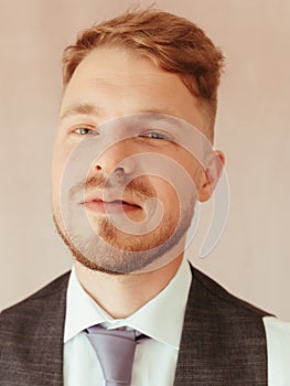 fashion young man wearing black tuxedo, grain effect studio blond