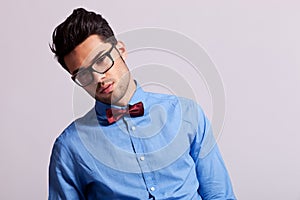 Fashion young man wearing glasses and bow tie