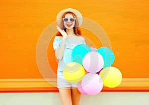 Fashion young smiling woman with an air colorful balloons